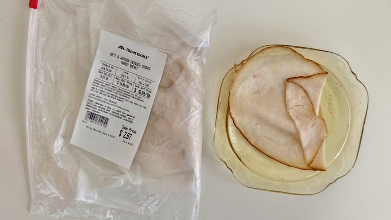 One slice of Mesquite Smoked Turkey Breast on a plate