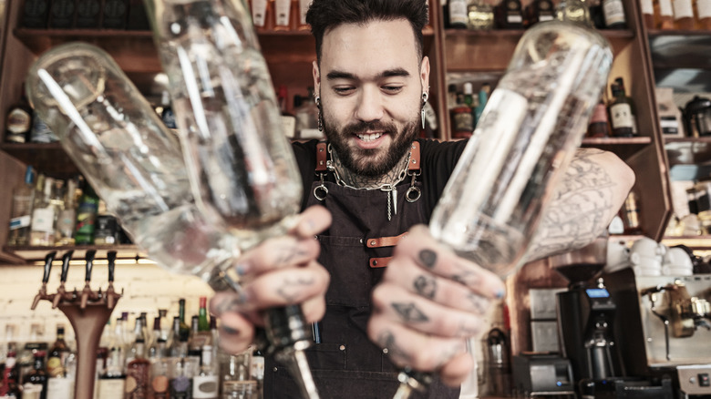 Bartender pouring three bottles at once
