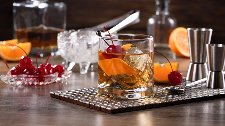 Old fashioned cocktail with garnishes on the bar