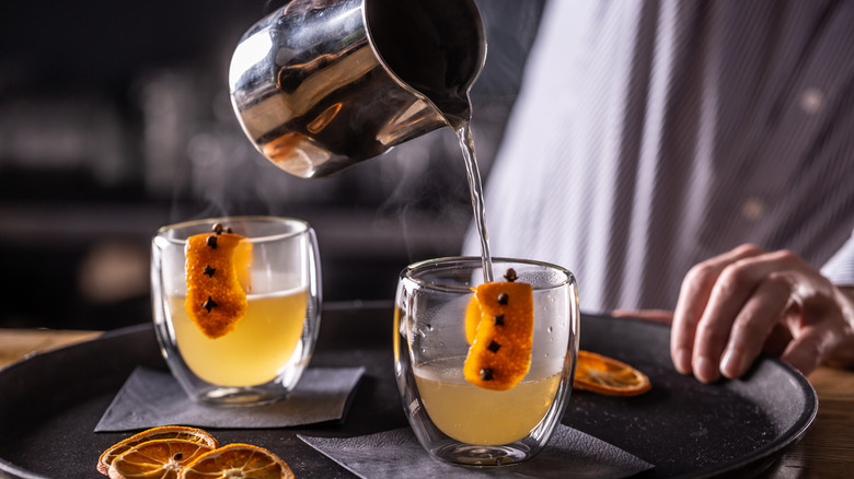 Bartender pouring hot toddy cocktails