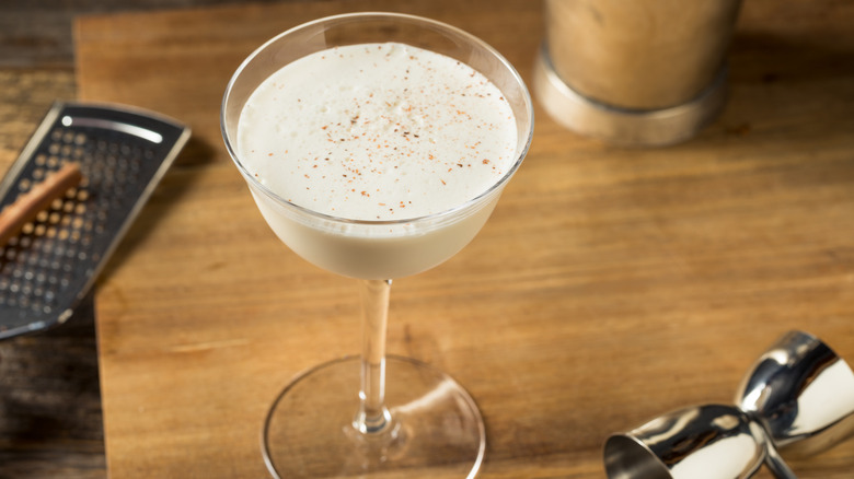 Bourbon milk punch on wooden cutting board