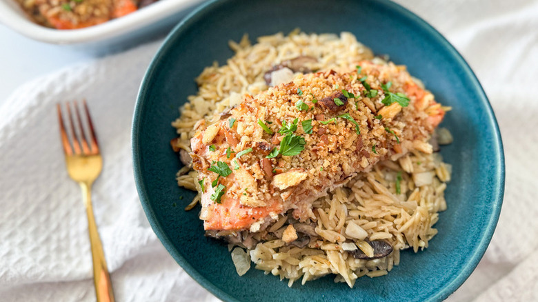 Honey mustard salmon and orzo in blue bowl