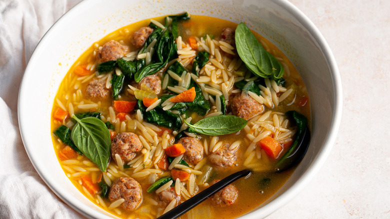 Bowl of sausage and vegetable orzo soup