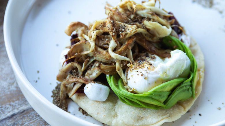 Burrata served on taco with oyster mushrooms and avocado