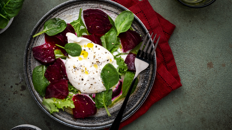 Overhead shot of burrata served on beet salad