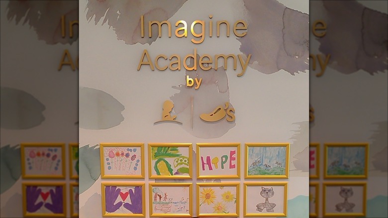 Imagine Academy sign with children's drawings underneath