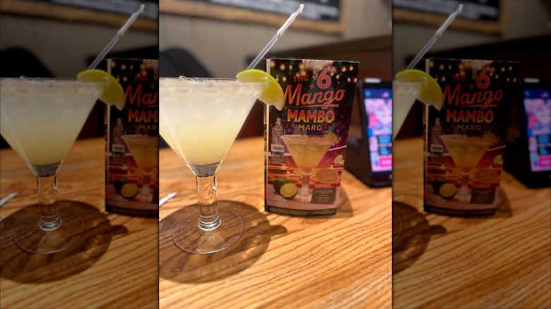 Chili's margarita with 6 Mango Mambo Marg ad on table