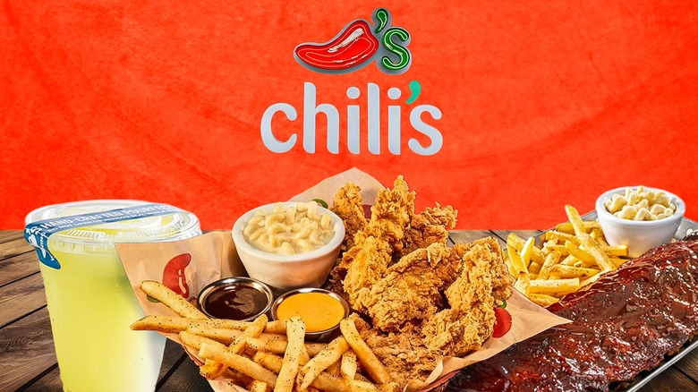 margarita, chicken fingers, ribs, and sides on a wooden table with a red Chili's background