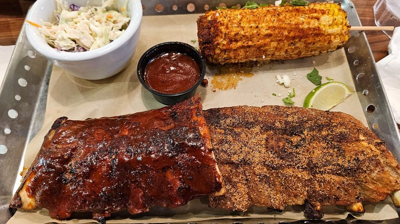 Platter of ribs at Chili's with coleslaw, corn on the cob, bbq sauce, and a lime wedge