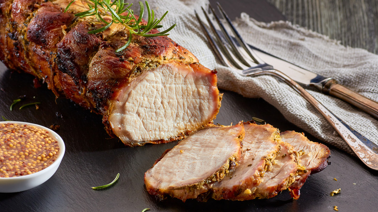 Grilled and baked pork loin sliced with mustard