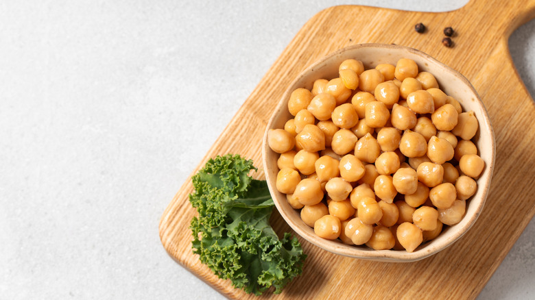Canned chickpeas in a white wooden bowl