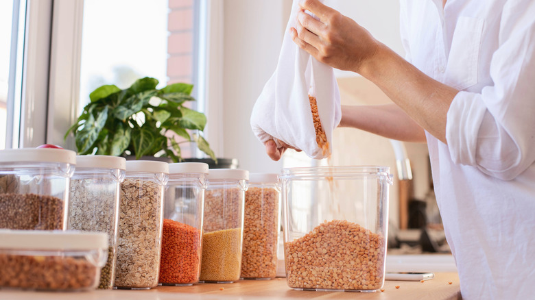 Pouring dried good from packaging into air tight containers