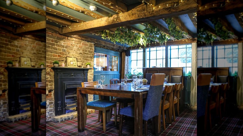 Dining table in the Ostrich Inn in front of fireplace