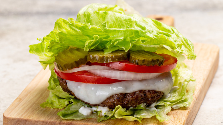 lettuce wrapped burger on a cutting board
