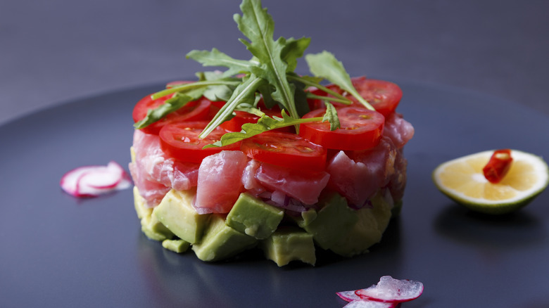 Tuna tartare on a plate with vegetable garnishes
