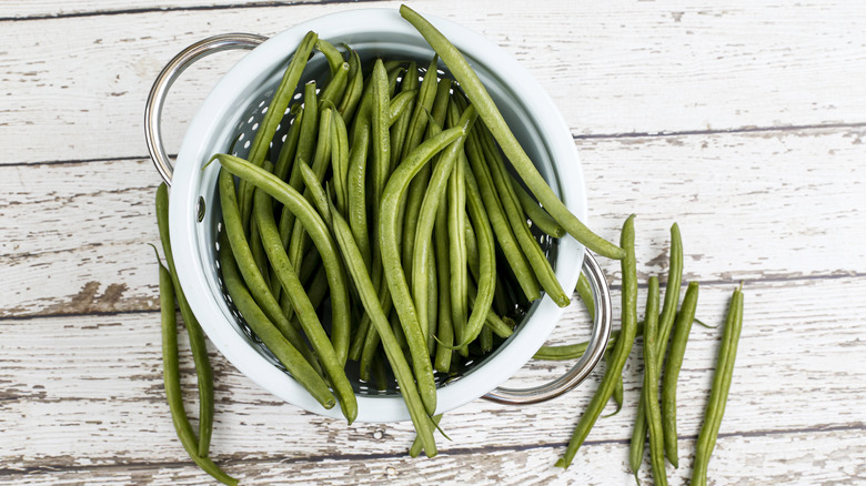 French green beans sitting on a weathered table
