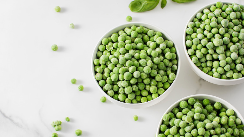 Three bowls of frozen green peas