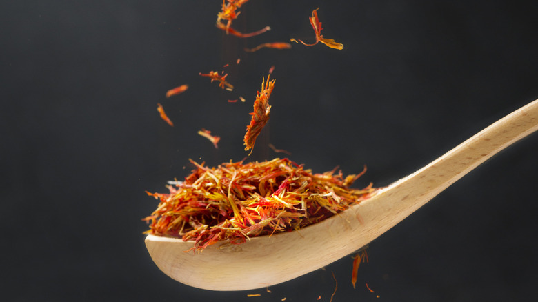 lose up view of saffron in wooden spoon