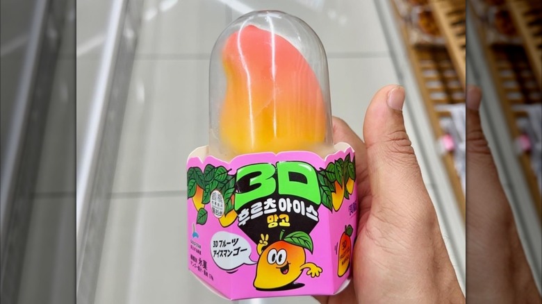 Hand holding mango 3D mango ice cream popsicle
