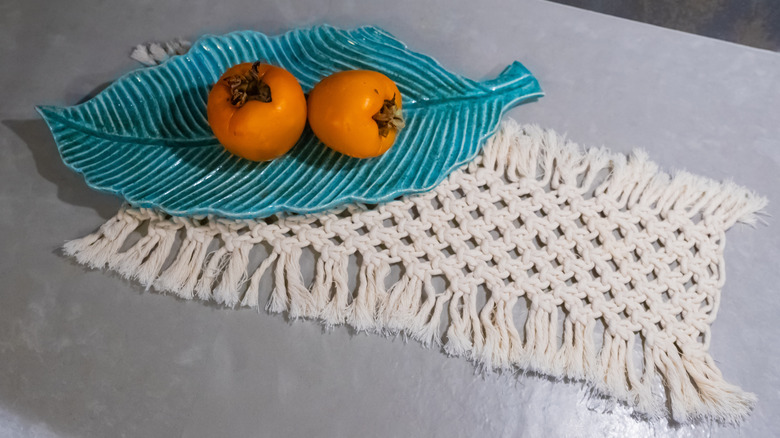 bowl on macrame woven piece in kitchen