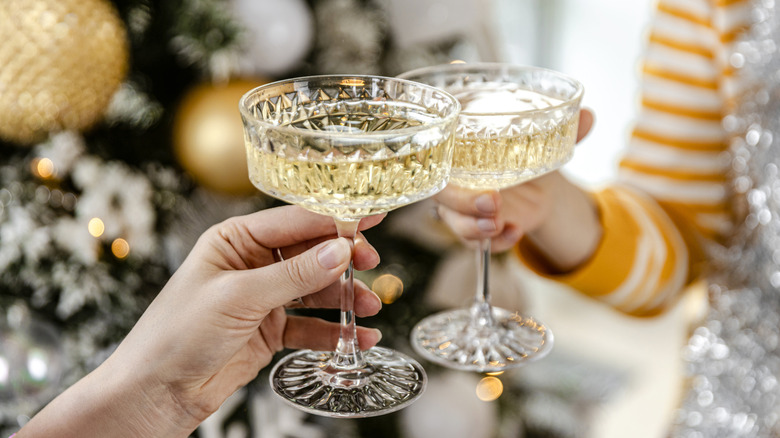 Giving a toast with champagne crystal glasses
