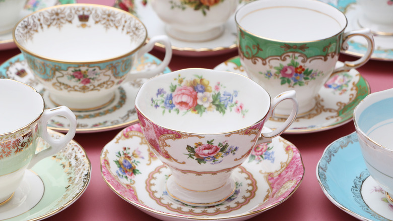 A variety of rose-patterned teacups and saucers