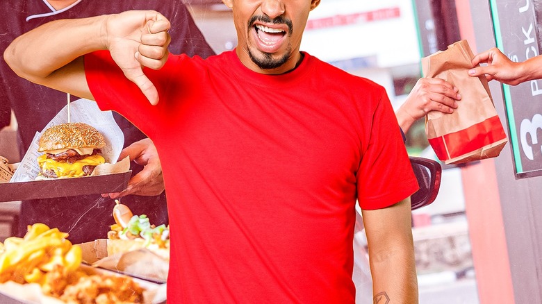 Man giving a thumbs down over food