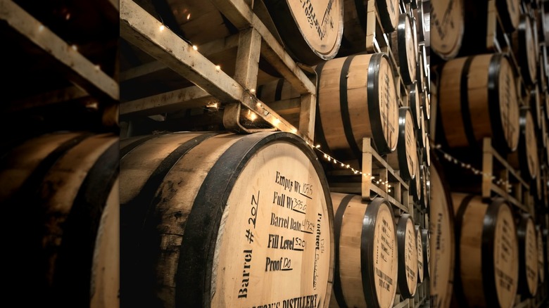 Stacked barrels of bourbon stamped with Walton's Distillery label.