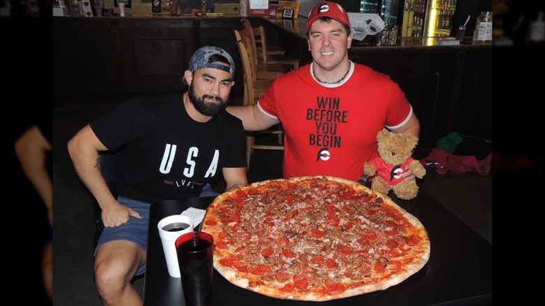 Randy Santel and Nathan Figueroa with the Carnivoe Challenge pizza