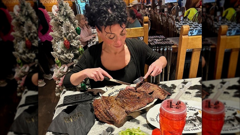 Customer eating holding knife and ford with 72-ounce steak