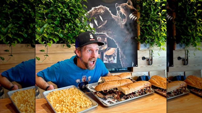 Man being shocked at the Bearwch challenge giant subs and tray of mac and cheese