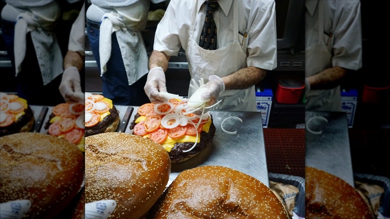 Assembling one of the burger challenges and adding onions