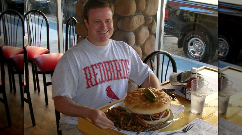Customer with the burger food challenge from Kooky Canuck