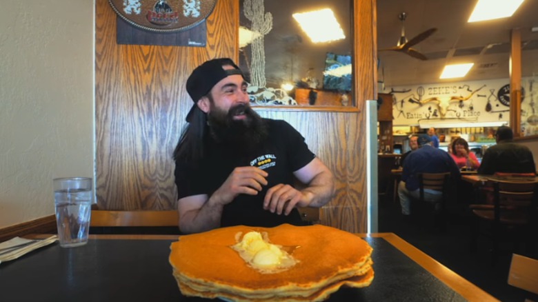 Adam Moran laughing at a table with wagon wheel pancakes