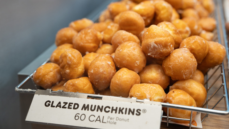 A basket of Glazed Munchkins on the sales shelf