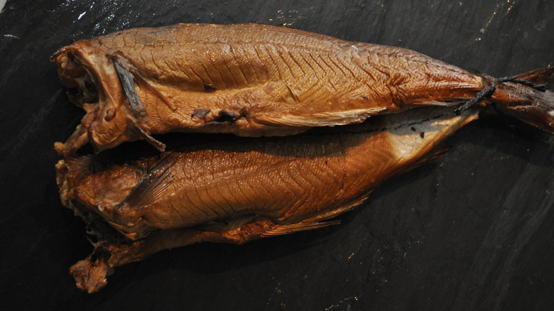 Abroath smokies lying on dark background