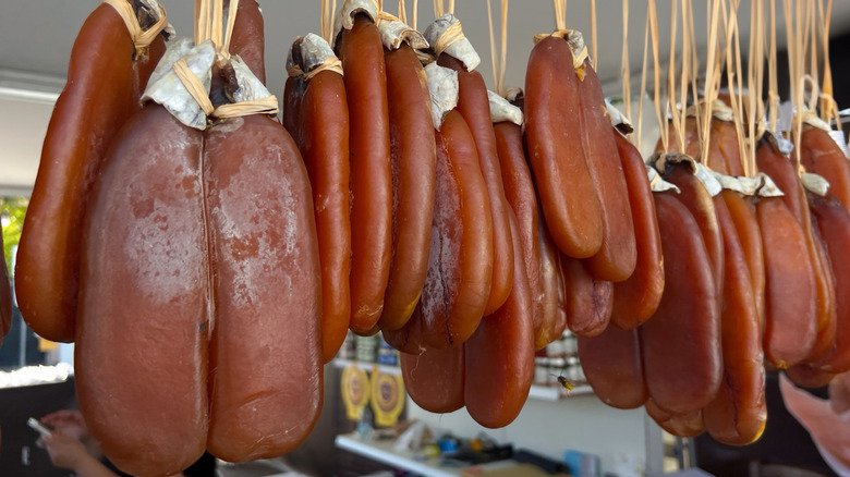 Slabs of bottarga hanging at outdoor market