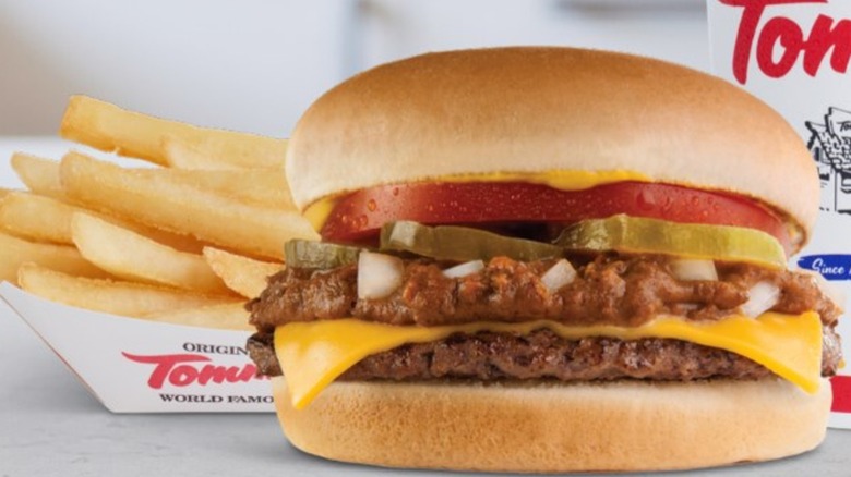 Burger with chili from Original Tommy's with fries and drink in background
