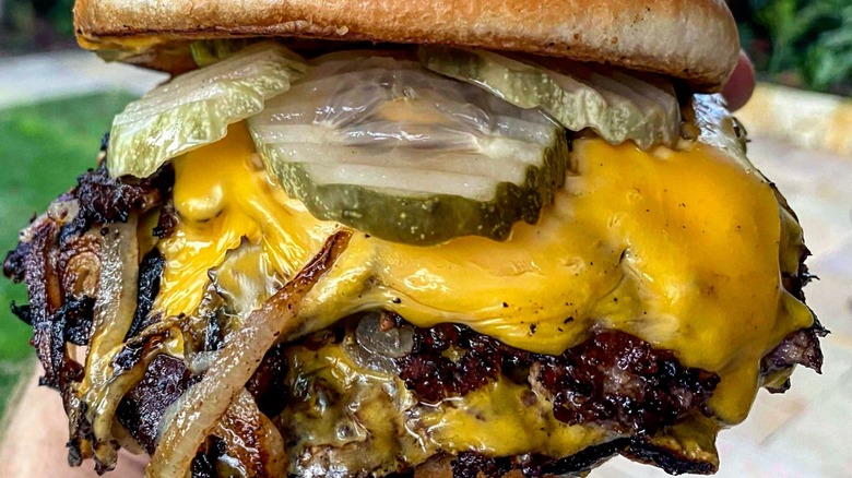 Onion burger with cheese and pickles