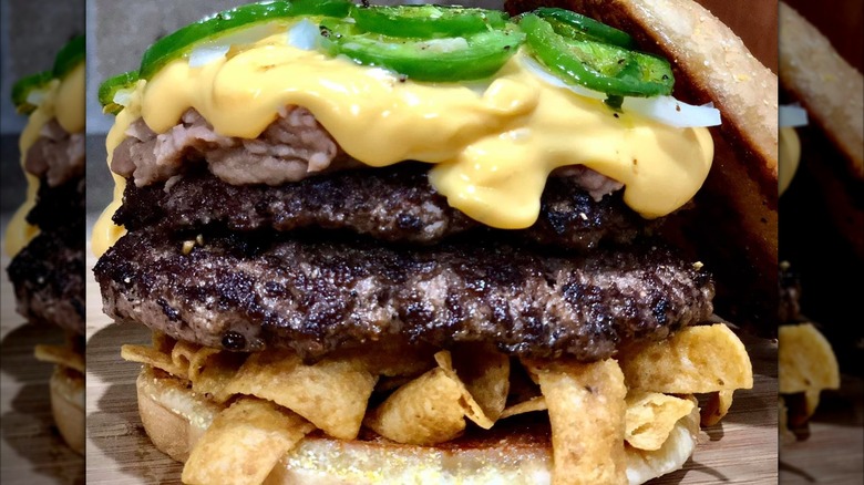 Burger with Fritos, refried beans, cheese, and jalapenos