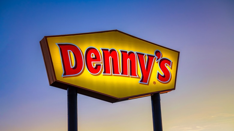 Denny's sign against a blue sky