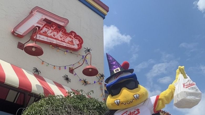 Mascot standing outside a Fricker's Restaurant