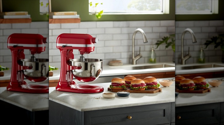 Red Kitchenaid mixer on countertop with hamburgers