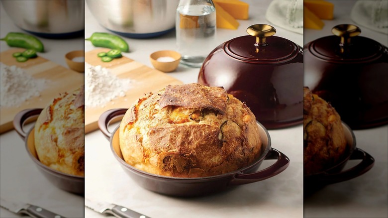 Cast iron bread oven holding baked bread on countertop