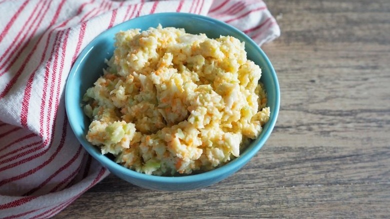 Cabbage and carrot slaw in blue bowl