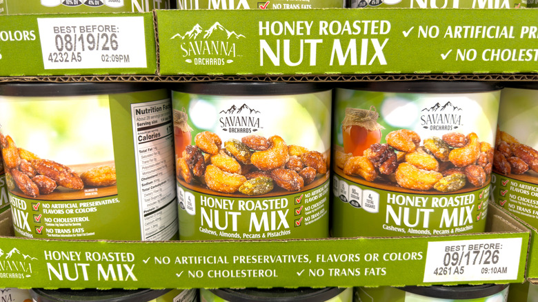 Green containers of honey roasted nut mix in the store