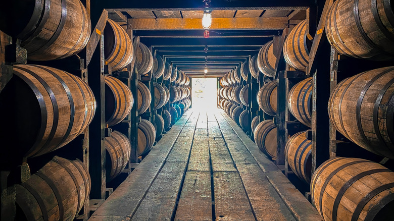 A rickhouse used for storing bourbon with dozens of barrels being stored