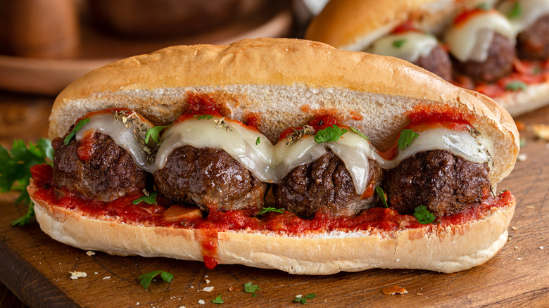 Perfectly loaded meatball sub sandwich on a cutting board