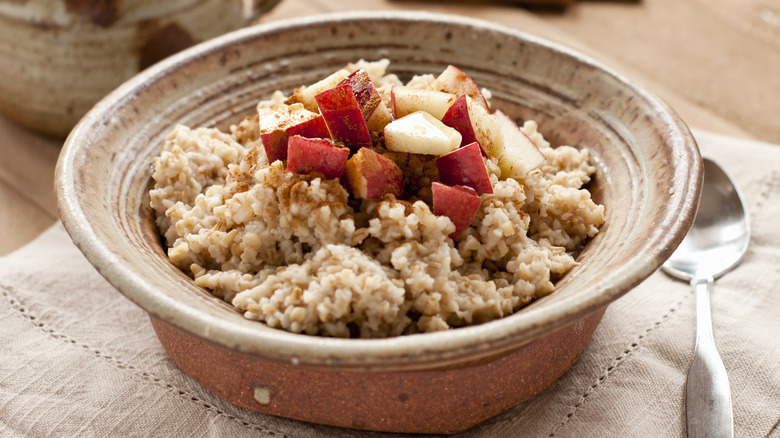 bowl of oatmeal topped with apples