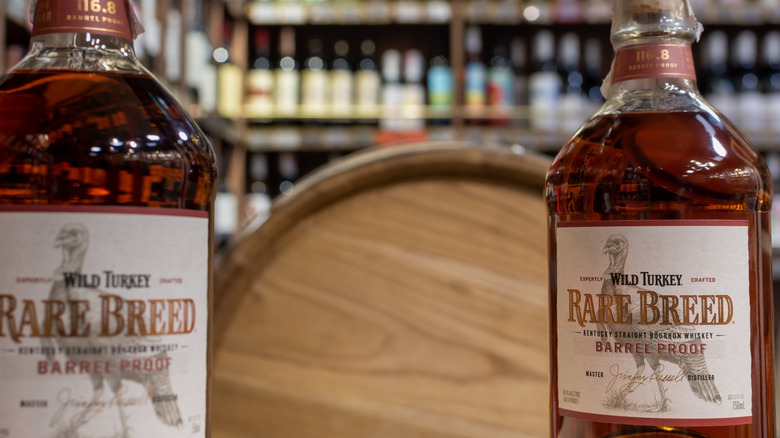 A close up of two bottles of Wild Turkey Rare breed inside of a liquor store
